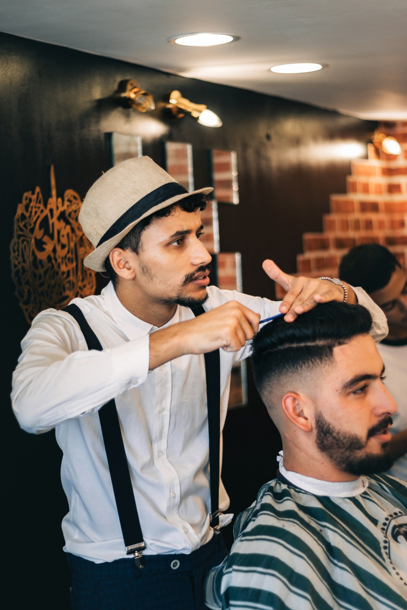 Barber talking through a cut with a client in the chair