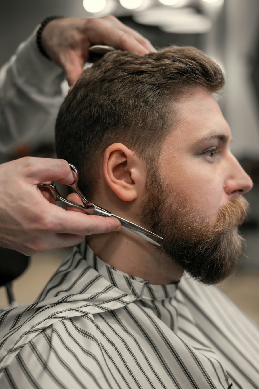 Barber trimming a full beard